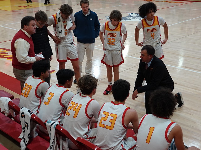 Coach Powers talks to his team during a timeout in their game versus Seaside. The Breakers would go on to win 85-27.