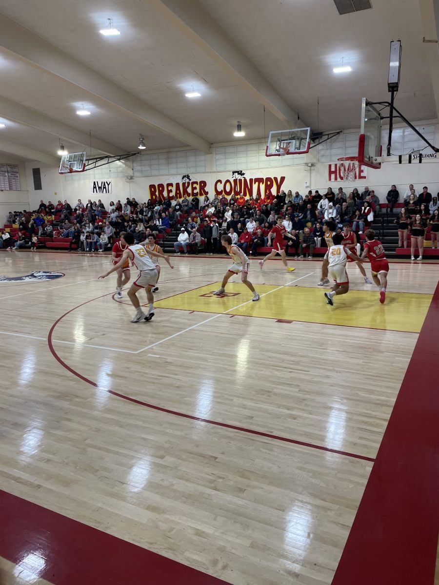 Sophomores Andrew Nimri and Sergen Serttunc guard Carmel player Warren Blut on a drive.