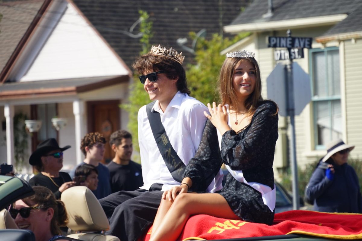 Homecoming King and Queen, Milo Nothnagle and Yeva Yevdash, following the homecoming floats in the parade
