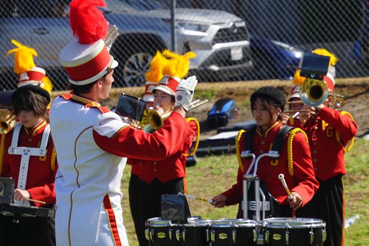 Drum Major Conor O'Brien conducting during the Butterfly Bazaar